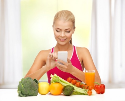 woman with fruits, vegetables and smartphone