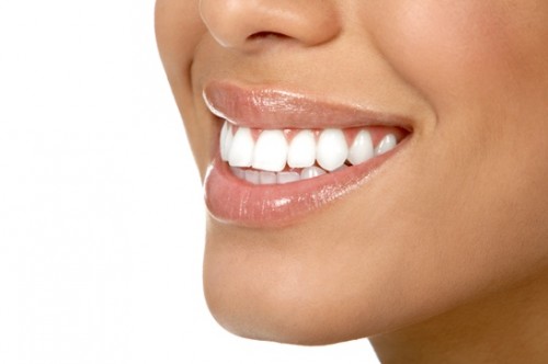 Beautiful young woman teeth. Isolated over  white background