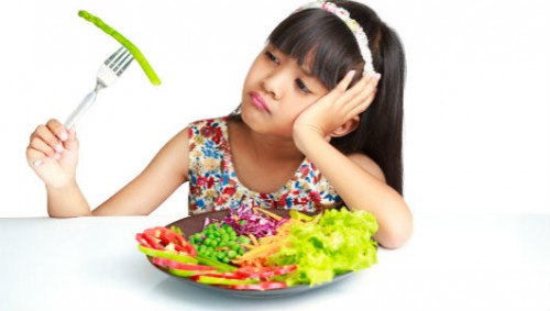 child eating veggies